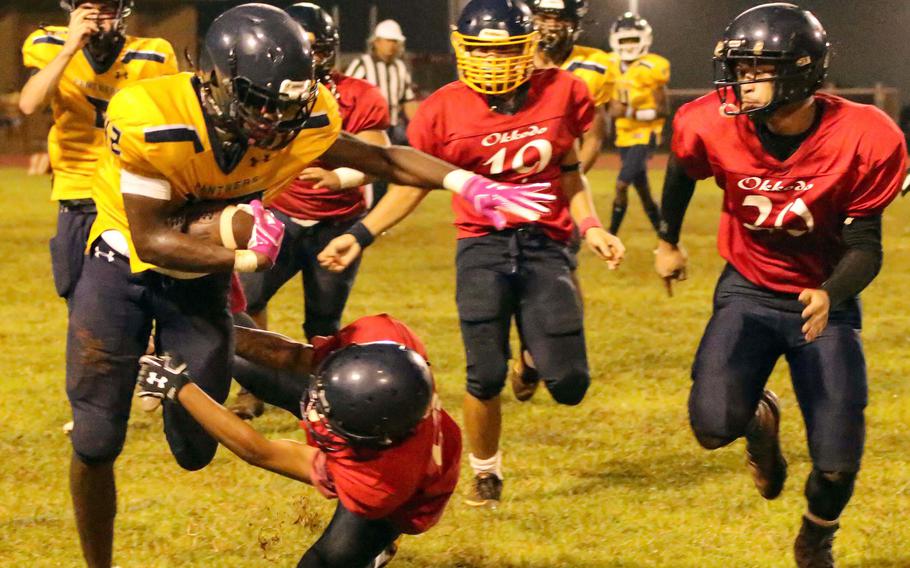Guam High's Cameron Brantley tries to avoid three Okkodo defenders.