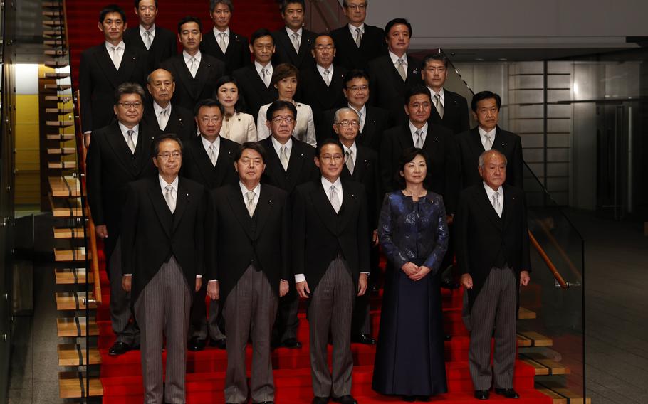 Japan’s Prime Minister Fumio Kishida, center, front row, and his cabinet ministers pose for a photo session at Kantei, the prime minister’s official residence, in Tokyo, Japan, Wednesday, Nov. 10, 2021. 