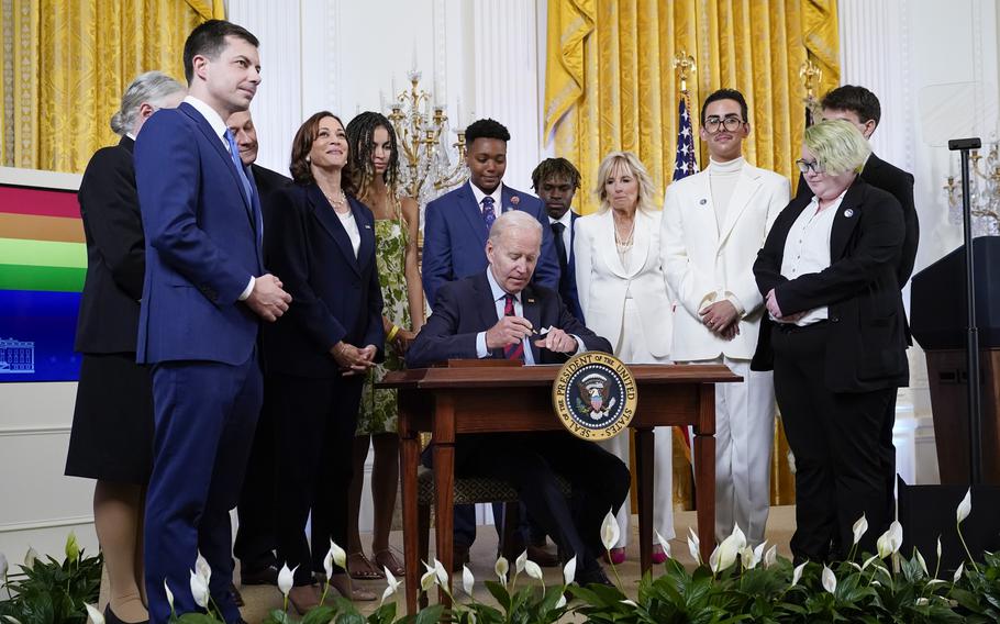 President Joe Biden signs an executive order at an event to celebrate Pride Month in the East Room of the White House, Wednesday, June 15, 2022, in Washington.