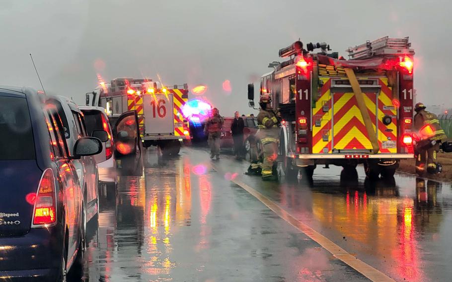 Emergency workers respond to a car accident near the runway at Yokota Air Base, Japan, Wednesday, Nov. 23, 2022.