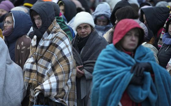 FILE - Refugees, mostly women and children, wait in a crowd for transportation after fleeing from the Ukraine and arriving at the border crossing in Medyka, Poland, on March 7, 2022. Russia’s invasion of Ukraine has driven some 14 million Ukrainians from their homes in “the fastest, largest displacement witnessed in decades,” sparking an increase in the number of refugees and displaced people worldwide to more than 103 million, the U.N. refugee chief said Wednesday, Nov. 2, 2022. (AP Photo/Markus Schreiber, File)