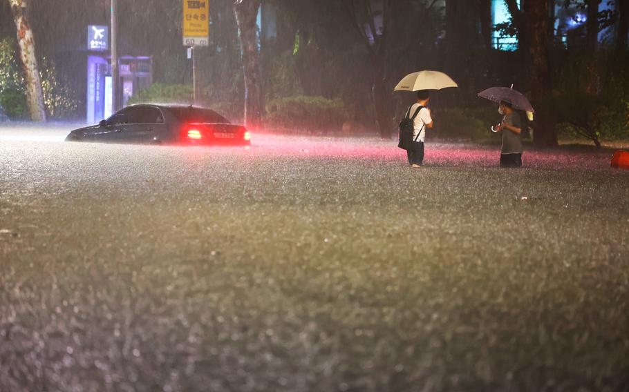 Heavy rains drenched South Korea's capital region, turning the streets of Seoul's affluent Gangnam district into a river, leaving submerged vehicles and overwhelming public transport systems.