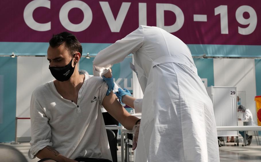 In this July 12, 2021, file photo, a medical worker administers a shot of Russia’s Sputnik V coronavirus vaccine at a vaccination center in Gostinny Dvor, a huge exhibition place in Moscow, Russia. In Russia, it’s common to get an antibody test and share the results. The tests are cheap, widely available and actively marketed by private clinics nationwide, and their use appears to be a factor in the country’s low vaccination rate even as daily deaths and infections are rising again.