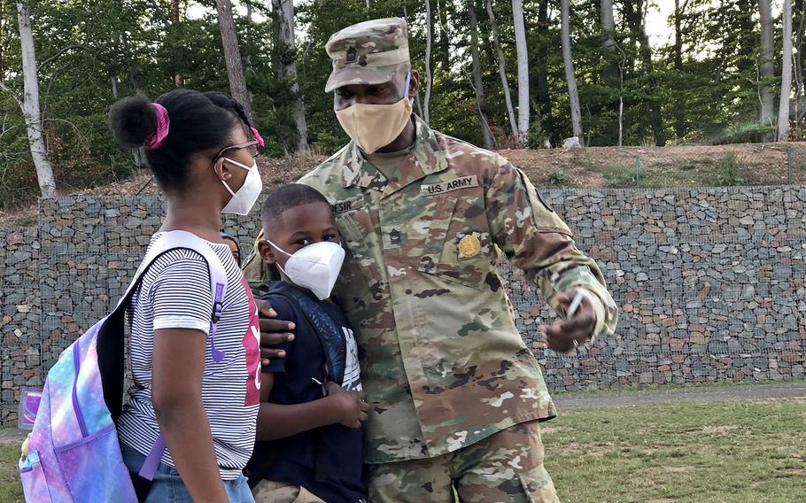 Master Sgt. Faustin Desir, 21st Theater Sustainment Command, says goodbye to his kids before they walk to their classes at Vogelweh Elementary School, Germany, Aug. 24, 2020. 