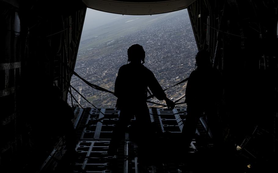A U.S. Air Force airman stands on the ramp of a C-130J Combat King II after airdropping humanitarian aid destined for Gaza on Tuesday, March 5, 2024.