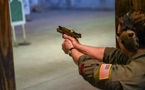 U.S. Air Force Capt. Tyler Moore, 97th Operations Support Squadron C-17 Globemaster III  aircraft evaluator pilot, fires a M18 pistol during the Combat Arms Training and Maintenance (CATM) small arms course at Altus Air Force Base, Oklahoma, May 22, 2025. Airmen in the CATM small arms course must shoot from various positions during their exam to complete the course. (U.S. Air Force photo by Airman 1st Class Nathan Langston)