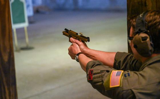 U.S. Air Force Capt. Tyler Moore, 97th Operations Support Squadron C-17 Globemaster III  aircraft evaluator pilot, fires a M18 pistol during the Combat Arms Training and Maintenance (CATM) small arms course at Altus Air Force Base, Oklahoma, May 22, 2025. Airmen in the CATM small arms course must shoot from various positions during their exam to complete the course. (U.S. Air Force photo by Airman 1st Class Nathan Langston)