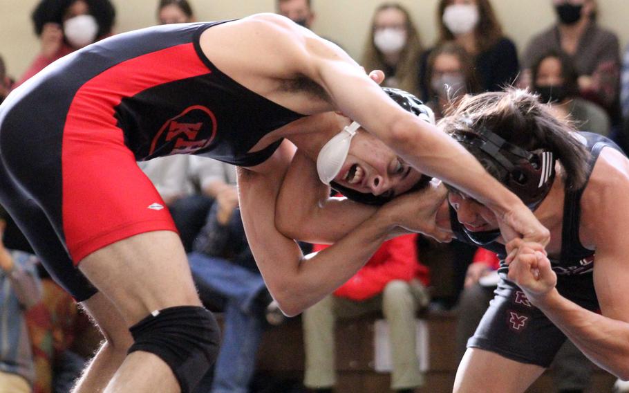 Nile C. Kinnick's Angel Rodrigues and Matthew C. Perry's John Shaver square off at 129 pounds during Saturday's DODEA-Japan wrestling dual meet. Rodrigues decisioned Shaver 8-2 and the Red Devils won the dual meet 39-22.
