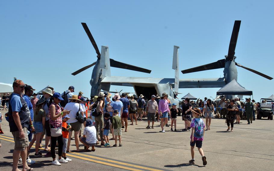 People line up to see inside a Marine Corps MV-22 Osprey during an open house at Royal Australian Air Force Base Darwin in Australia, Saturday, Aug. 27, 2022.