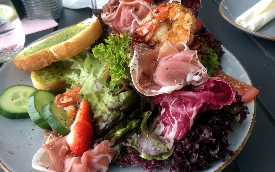 The schmankerl salad at Degenhardt in Wiesbaden, Germany. Schmankerl, a word often used in Bavaria, translates to delicacy or treat. And with shrimp, Parma ham and Parmesan cheese shavings, the salad was indeed a treat.
