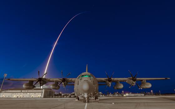 A 920th Rescue Wing HC-130J Combat King II aircraft sits on the flight line at Patrick Space Force Base, Florida, as the Inspiration4 rocket launches in the background. Inspiration4 is the world's first all-civilian mission to orbit. (U.S. Air Force photo by Master Sgt. Kelly Goonan)
