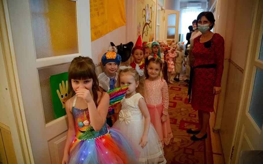 Eva, 6, left, Vasylyna Nikolayeva’s daughter, prepares for a talent show at her kindergarten.