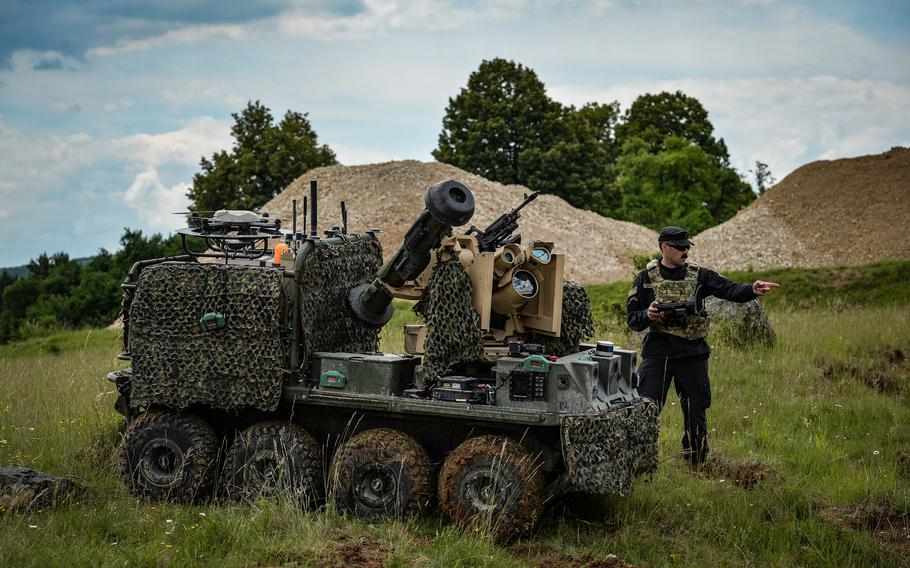 Sgt. 1st Class Joshua De Palma, a scout platoon sergeant with 1st Battalion, 4th Infantry Regiment, moves a Project Origin robotic combat vehicle at the Joint Multinational Readiness Center in Hohenfels, Germany, June 8, 2022. Project Origin unmanned ground vehicles are designed to support Army maneuvers by providing a variety of weapons and sensor attachment kits and was tested and demonstrated during exercise Combined Resolve 17. 