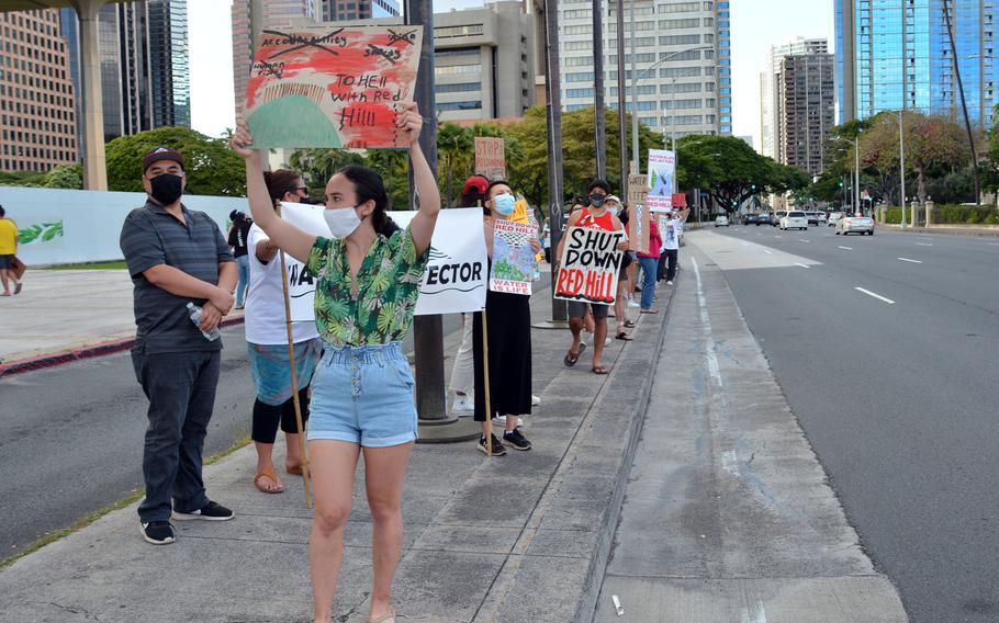Protesters calling for the permanent closure of the Navy’s Red Hill fuel storage facility hold placards in front of the Hawaii State Capitol in Honolulu, Feb. 11, 2022.