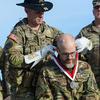 Jay Tenison, an Army tanker veteran diagnosed with terminal cancer, is awarded the Order of St. George by Army Col. Ryan Kranc, the commander of the 316th Cavalry Brigade, at Fort Moore, Ga., on Dec. 5, 2023. The award recognizes achievement among tankers and cavalry troopers. Tenison received the honor after firing a tank one last time. (Corey Dickstein/Stars and Stripes)