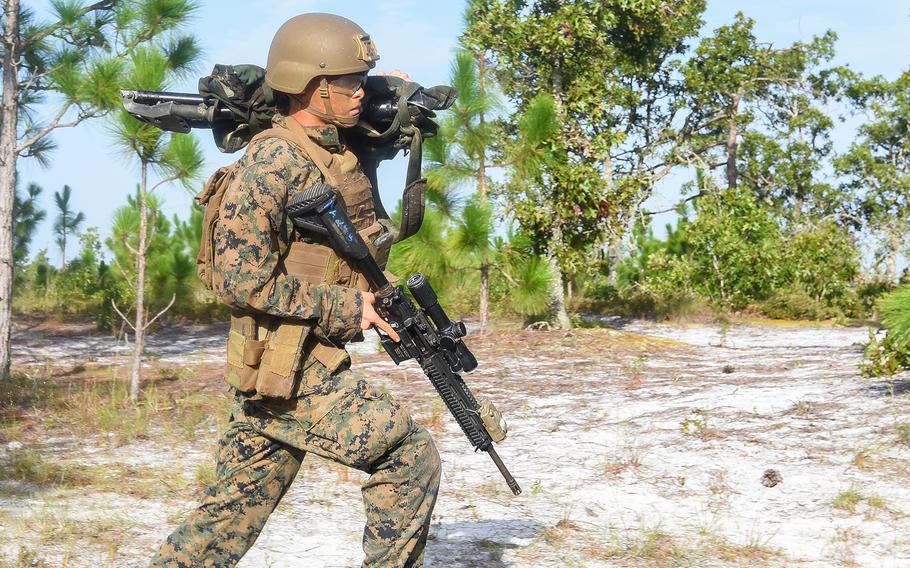 A Marine infantry student at Camp Lejeune, N.C., practices setting up an ambush in a live-fire training event Aug. 27, 2021, during their 12th week of initial infantry training as part of a pilot program meant to drastically change the way the Corps trains its infantrymen. The pilot program expands infantry training from nine to 14 weeks and places Marines in 14-person squads under a single instructor.