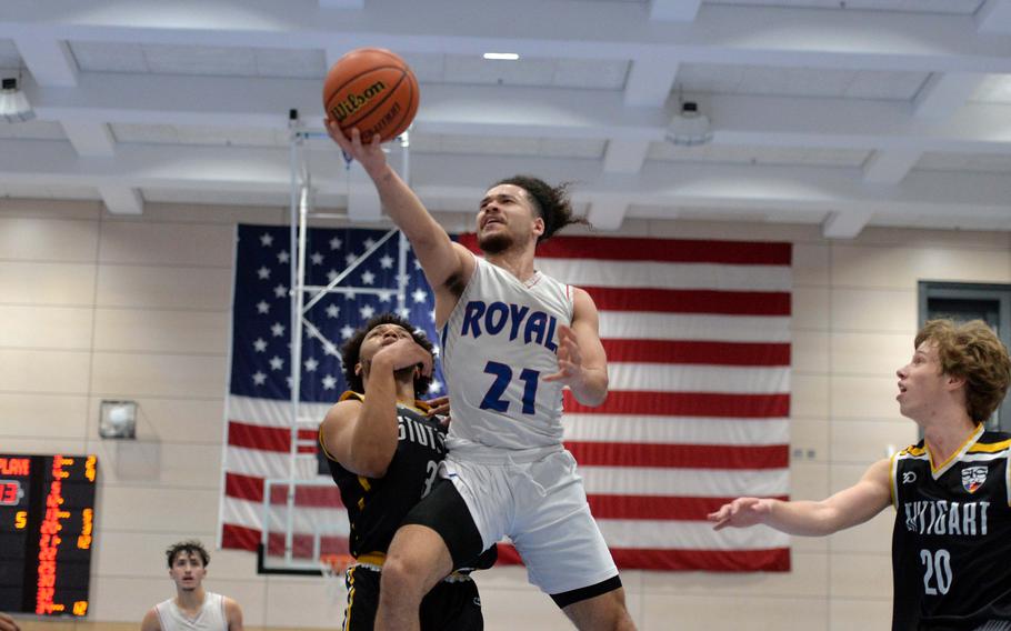 Ramstein’s Israel Rouse goes in for a basket against Stuttgart’s Trenton Jackson in the Division I championship game at the DODEA-Europe basketball championships in Ramstein, Germany, Feb. 18, 2023. Stuttgart took title with a 62-60 double overtime win.