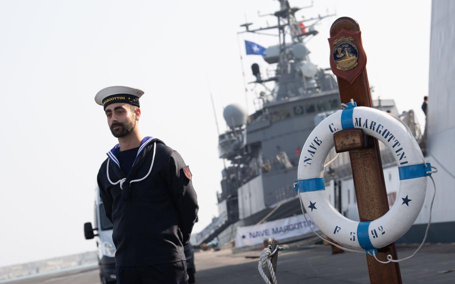 An Italian sailor provides security during a conference for NATO exercise Dynamic Manta aboard the Italian ship ITS Carlo Margottini in Catania harbor, Feb. 24, 2023. Ships, submarines, maritime patrol aircraft and personnel from nine allied nations are taking part in the exercise.