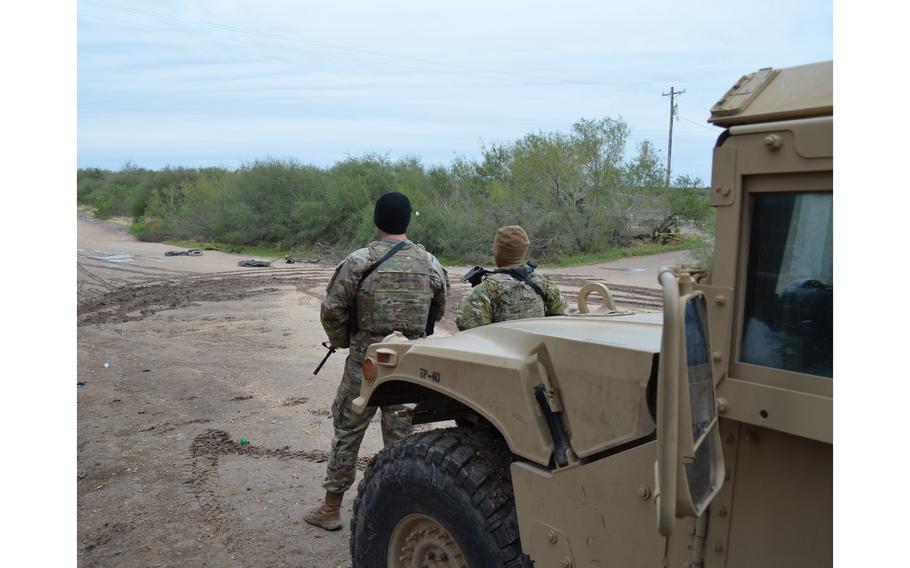 Two Texas National Guard soldiers work an observation post in Hidalgo County near the state’s border with Mexico as part of Operation Lone Star on Jan. 21, 2022. T