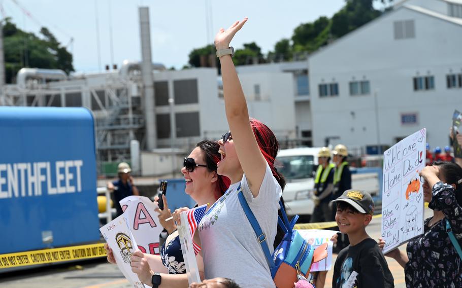 Friends and family of USS Blue Ridge sailors crowd the pier as the amphibious command ship returns.