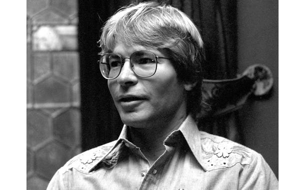 A portrait of a man in glasses, from the shoulders up.