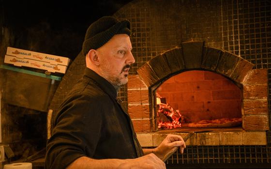 The owner, Sinan Jahic, cooks his pizzas in a wood-fired oven.