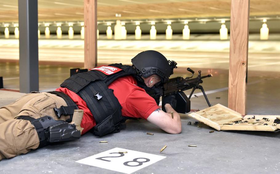 Combat firearms instructor James Hansen fires his weapon in the new Small-Arms Indoor range at Westover Air Reserve Base. Officials held a ribbon cutting ceremony for the new facility. 