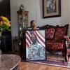 Anna Stanley sits on her couch in her living room.