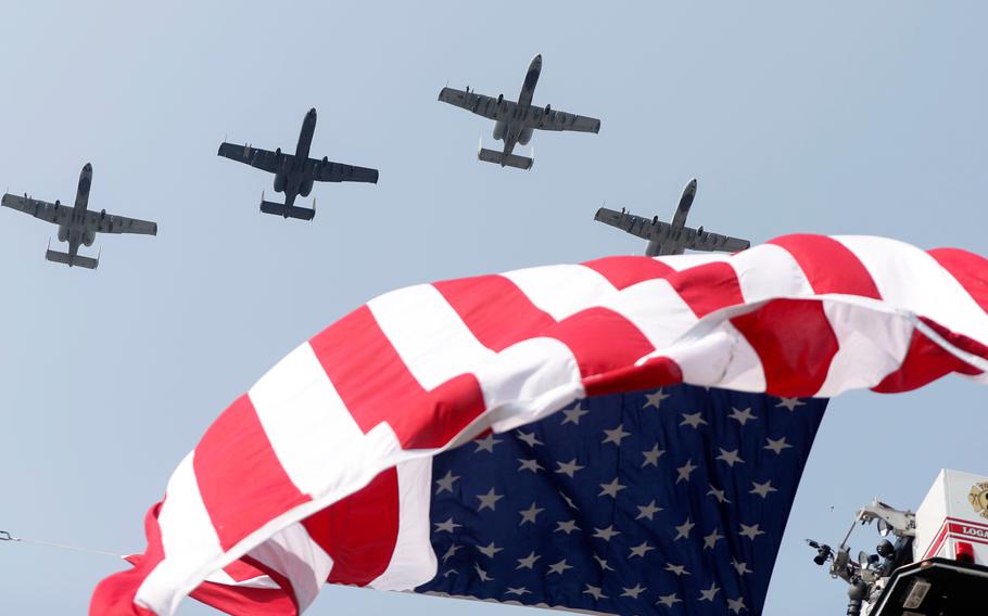 Planes fly above the funeral procession for Marine Corps Cpl. Humberto "Bert" Sanchez at the corner of 8th Street and East Market Street on Sept. 12, 2021, in Logansport, Ind.