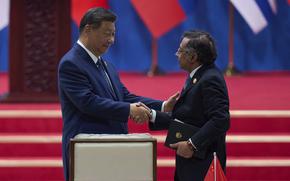 Chinese President Xi Jinping, left, shakes hands with Colombia's President Gustavo Petro after delivering his opening speech for the opening ceremony of the Fourth Ministerial Meeting of the Forum of China and Community of Latin American and Caribbean States at China National Convention Center in Beijing, Tuesday, May 13, 2025. (AP Photo/Andy Wong)