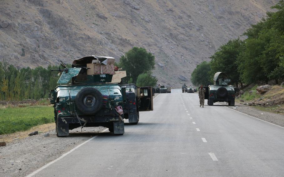 Afghan soldiers pause on a road at the front line of fighting between Taliban and Security forces near the city of Badakhshan, northern Afghanistan, Sunday, July 4, 2021. 