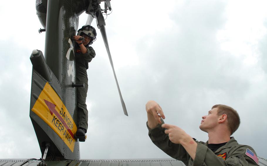 A sailor instructs a pre-flight inspection