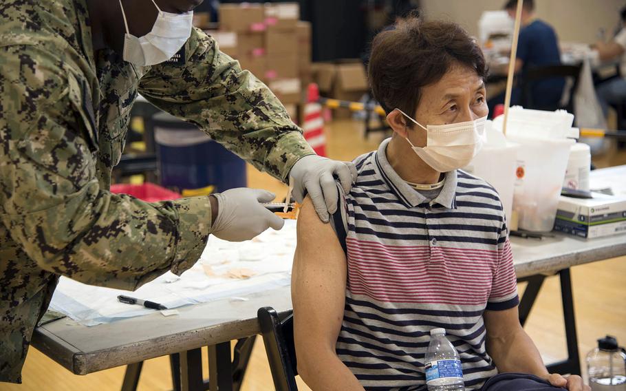 Budget analyst Hiroaki Kayama receives the Moderna COVID-19 vaccine at Yokosuka Naval Base, Japan, Friday, June 18,2021. 