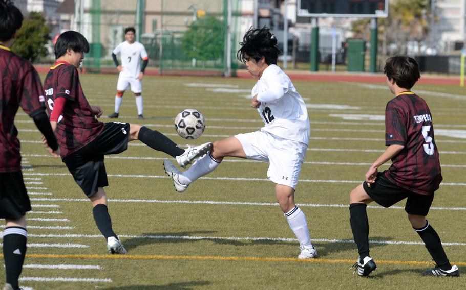 E.J. King’s Elijah Rene tries to play the ball against Marist Brothers during Friday’s Perry Cup boys soccer match. The Bulldogs won 1-0.