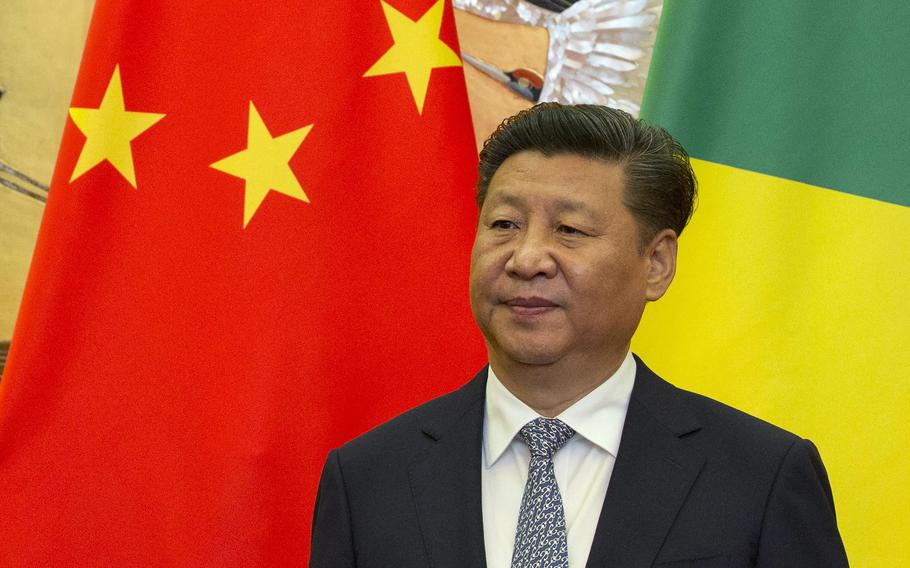 FILE - Chinese President Xi Jinping stands in front of national flags of China and Republic of Congo during a meeting with visting Congolese dignitaries at the Great Hall of the People in Beijing, China, Tuesday, July 5, 2016. China on Wednesday, Dec. 1, 2021, urged its citizens to leave three provinces in eastern Congo as violence intensifies in the mineral-rich region. 