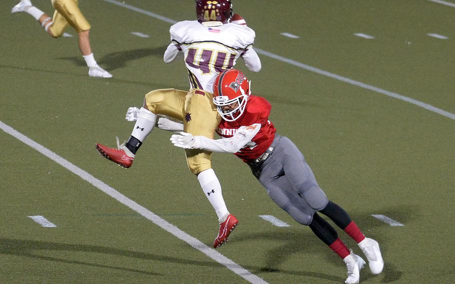 Matthew C. Perry's Denzel Gray gets tackled by Nile C. Kinnick's Daniel Burke.