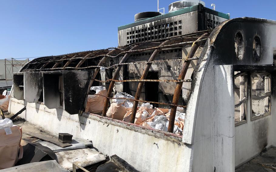 A tool shed atop the roof of a building in Chatan, Okinawa, was damaged by a fire, Sunday, Jan. 15, 2023.