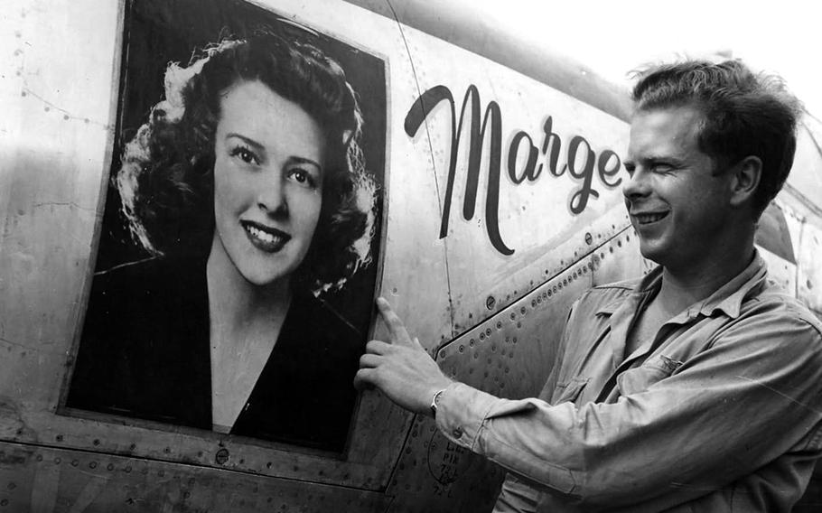 Richard Bong shows off the portrait of his girlfriend on the nose of his P-38 fighter in this photo taken in March 1944 in the Pacific.