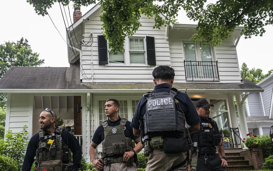 Law enforcement officers stand guard as protesters march past Supreme Court Justice Brett Kavanaugh’s home on June 8, 2022, in Chevy Chase, Maryland. 