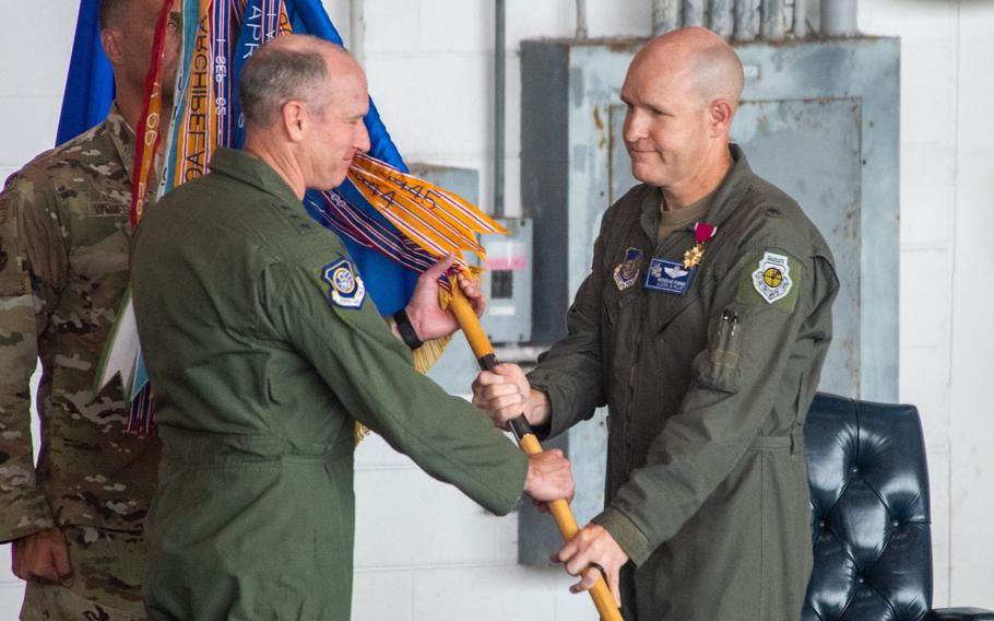 Brig. Gen. Nicholas Evans passes the 18th Wing guidon to Lt. Gen. Stephen Jost.