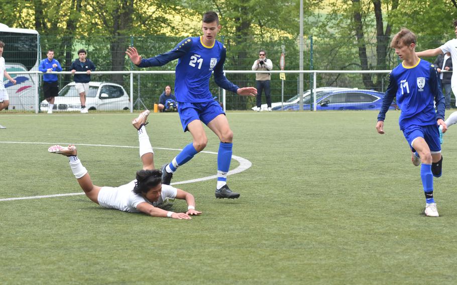 Ramstein’s Shaun Young goes sprawling after being inadvertently tripped by Wiesbaden’s Robert Dugandzic in the DODEA-Europe Division I soccer semifinals Wednesday, May 17, 2023.