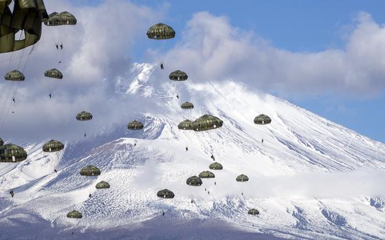 Japan Ground Self-Defense Force paratroopers assigned to the 1st Airborne Brigade descend from an Air Force C-130J Super Hercules over the East Fuji Maneuver Area, Japan, Tuesday, Jan. 31, 2023.
