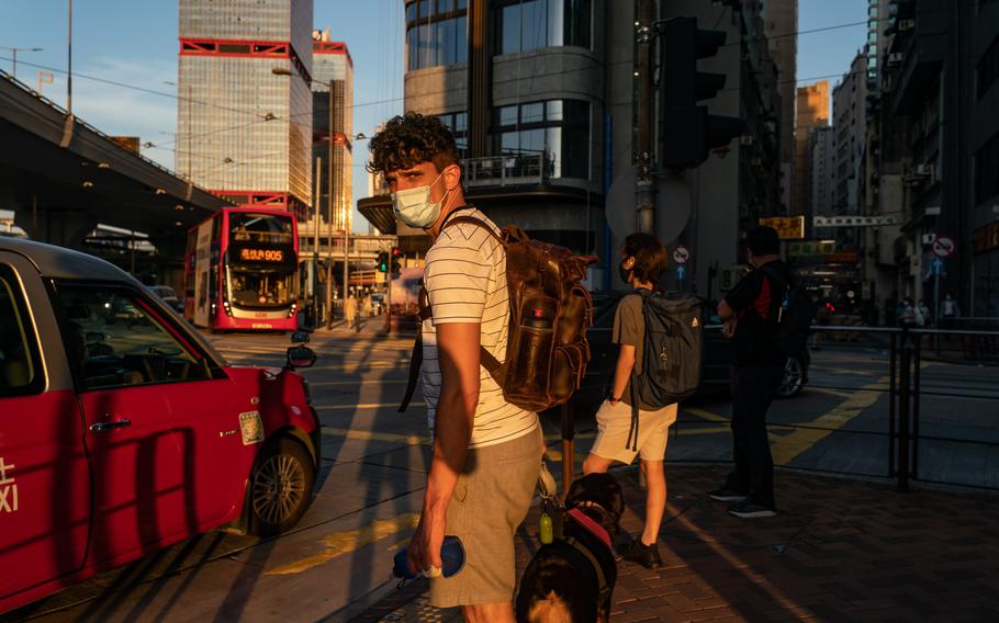 Samuel Phillip Bickett walks his dog, Mui Mui, on Aug. 17, 2021, in Hong Kong. The corporate lawyer was convicted and jailed for assaulting an officer. 