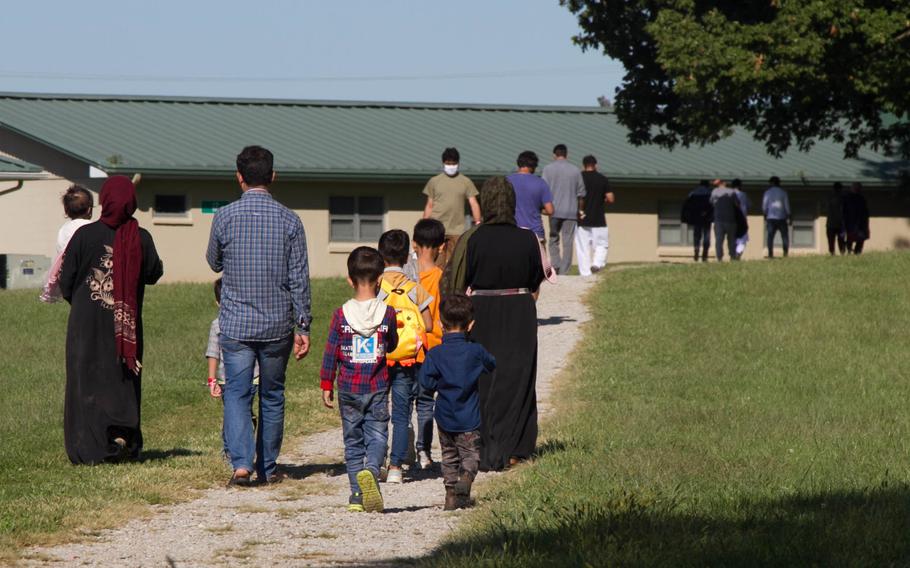 Afghan evacuees walking a nature trail in September 2021 at Camp Atterbury, Ind. Soldiers at the base provided transportation, temporary housing, medical screening and logistics support as part of Operation Allies Welcome.