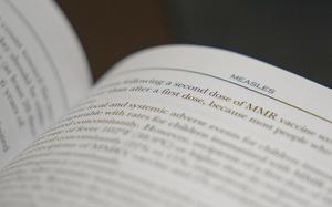 FILE - A section on measles is visible in the American Academy of Pediatrics Red Book seen at Hobbs Medical Clinic Monday, Feb. 24, 2025, in Hobbs, N.M. (AP Photo/Julio Cortez, File)