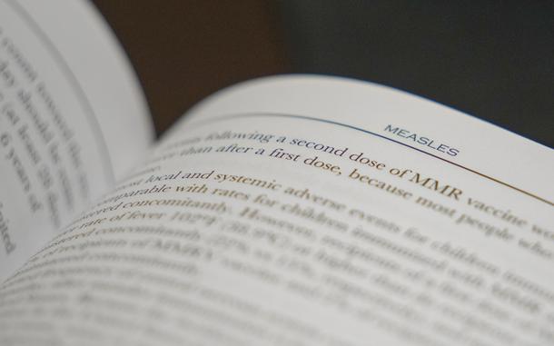FILE - A section on measles is visible in the American Academy of Pediatrics Red Book seen at Hobbs Medical Clinic Monday, Feb. 24, 2025, in Hobbs, N.M. (AP Photo/Julio Cortez, File)