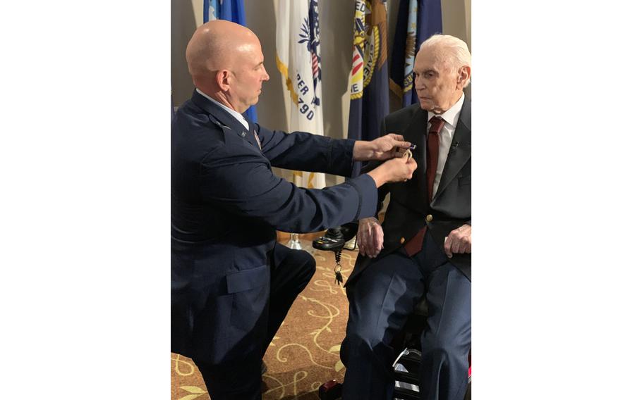 Air Force Brig. Gen. Dean Sniegowski, left, pins a Purple Heart on Malcolm Champagne, 102, for wounds received as B-17 navigator during a 1943 bombing raid over Germany, during a Sept. 15, 2023, ceremony.