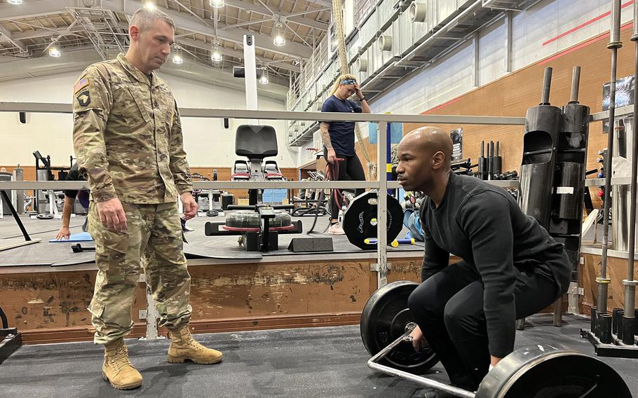 Sgt. 1st Class Jason Blowers, an Army recruiter, grades Air Force Tech. Sgt. Adam Wilks during an occupational physical assessment test at Yokota Air Base in western Tokyo, Jan. 5, 2023. 