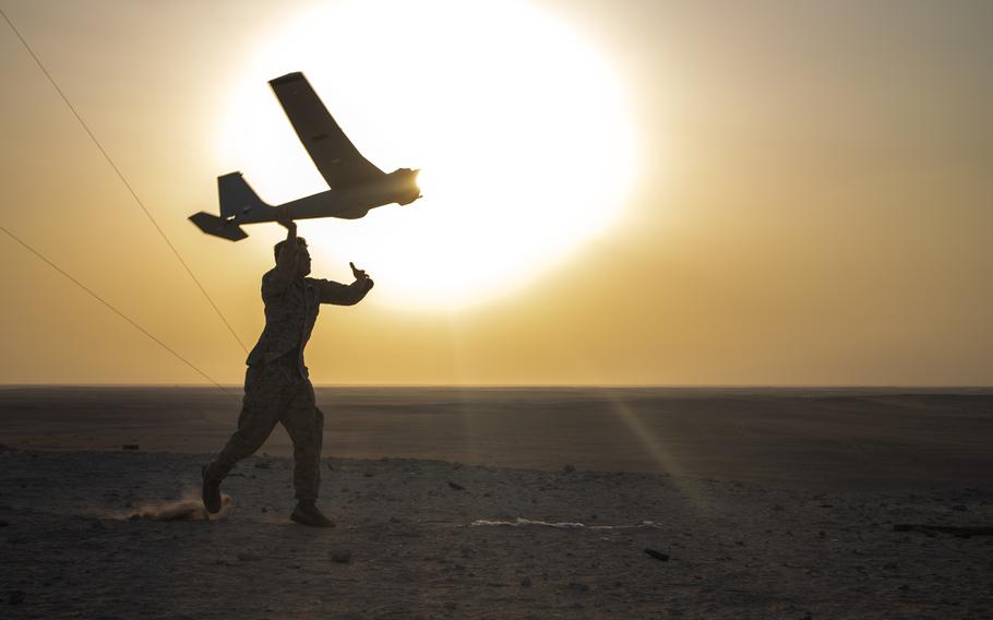 A Marine with India Company, 3rd Battalion, 5th Marine Regiment, 1st Marine Division, launches a RQ-20B Puma small, unmanned aircraft system in the United Arab Emirates on Sept. 22, 2022. 