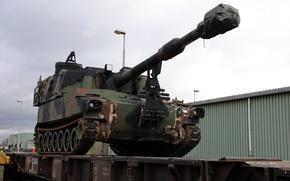 A M109A6 Paladin waits to be guided into position on a railcar in Eygelshoven, Netherlands, in 2019. Within three weeks, more than 700 pieces of equipment were moved to Poland. A Pentagon strategy that emphasizes unpredictable short-term deployments is more likely to risk escalation with Russia than a forward-based military presence, a Rand Corp. study found.